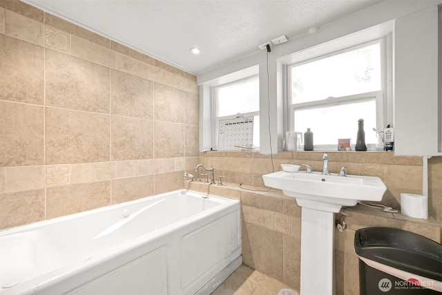 1501 Lakeway Dr, Bellingham, WA 98225 - bathroom featuring tile walls, a bath, and tile patterned flooring