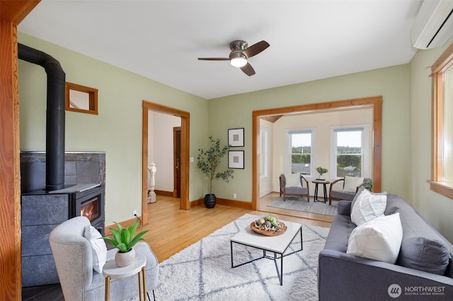 832 Willow St, Port Townsend, WA 98368 - living room featuring a wall mounted air conditioner, wood finished floors, and a ceiling fan