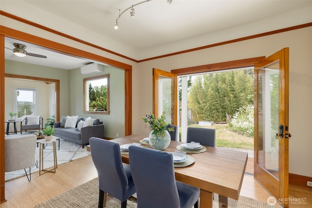 832 Willow St, Port Townsend, WA 98368 - dining space featuring light wood finished floors, a wall mounted AC, and french doors