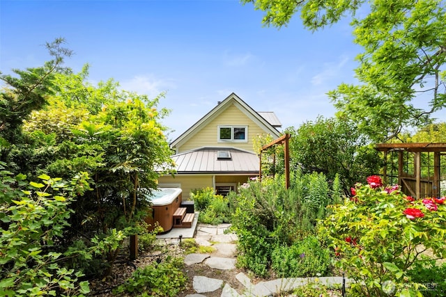 832 Willow St, Port Townsend, WA 98368 - back of property with a hot tub, a metal roof, and a standing seam roof