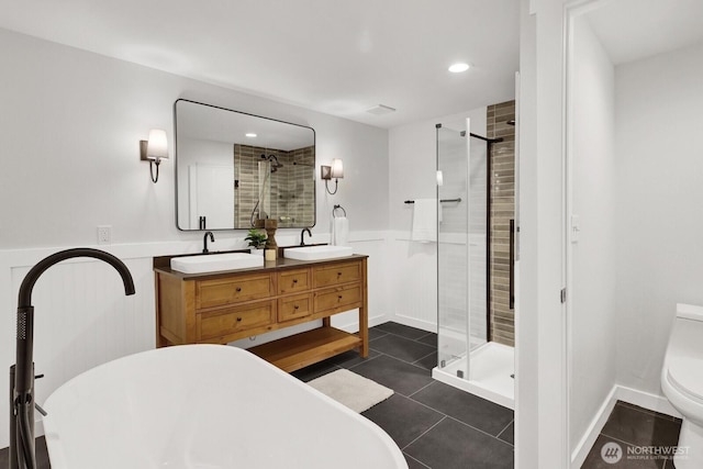 16071 Colony Rd, Bow, WA 98232 - bathroom featuring a shower stall, wainscoting, double vanity, a freestanding tub, and tile patterned flooring