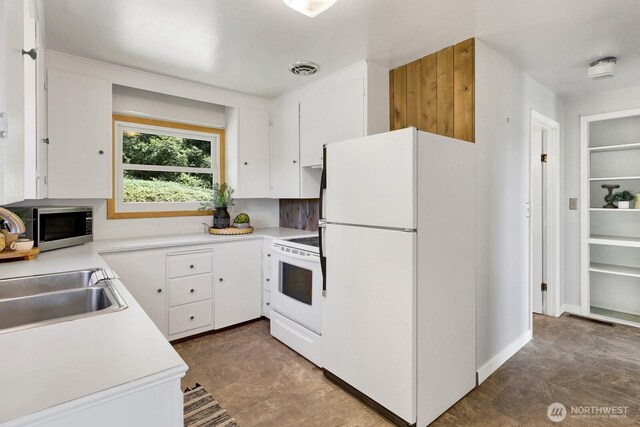 16071 Colony Rd, Bow, WA 98232 - kitchen featuring white appliances, white cabinetry, light countertops, and built in shelves