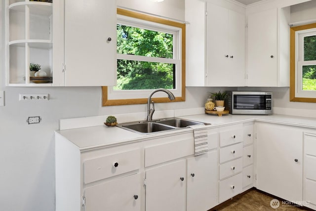 16071 Colony Rd, Bow, WA 98232 - kitchen with stainless steel microwave, light countertops, and white cabinetry