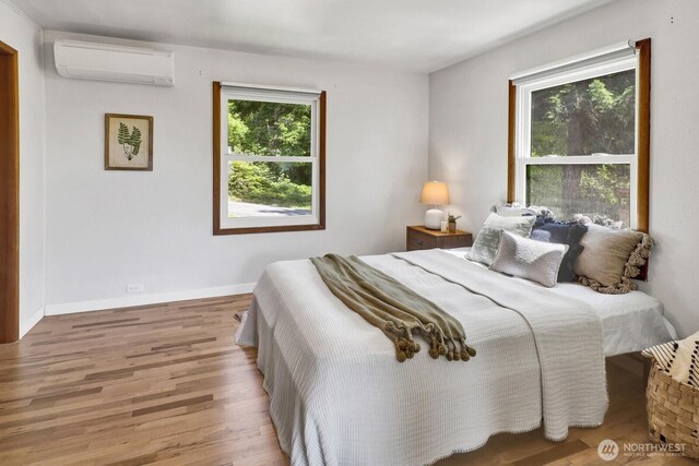 16071 Colony Rd, Bow, WA 98232 - bedroom with a wall mounted air conditioner and wood finished floors