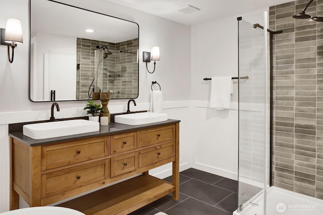 16071 Colony Rd, Bow, WA 98232 - bathroom featuring a stall shower, double vanity, tile patterned floors, and wainscoting