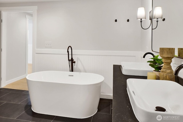 16071 Colony Rd, Bow, WA 98232 - bathroom with a wainscoted wall, tile patterned flooring, a freestanding bath, and double vanity