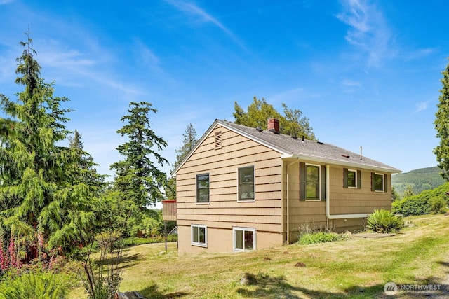 16071 Colony Rd, Bow, WA 98232 - view of side of home featuring a lawn and a chimney