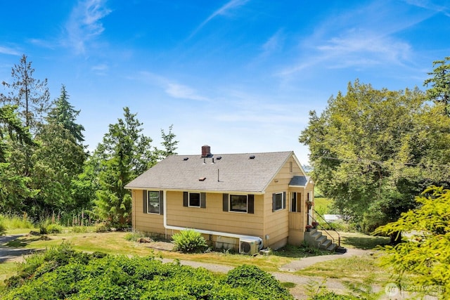 16071 Colony Rd, Bow, WA 98232 - rear view of property featuring roof with shingles and a chimney