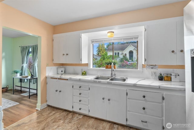 2319 Gale Pl, Everett, WA 98203 - kitchen featuring light countertops, white cabinets, and light wood-type flooring