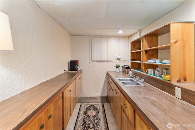 2319 Gale Pl, Everett, WA 98203 - kitchen with a textured wall, a paneled ceiling, brown cabinets, light tile patterned floors, and wooden counters
