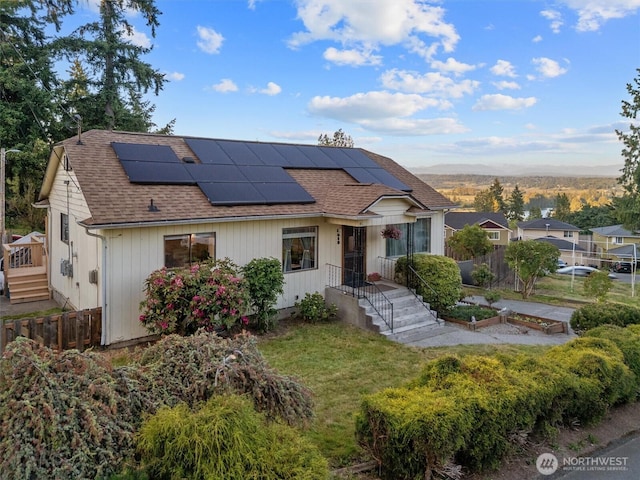 2319 Gale Pl, Everett, WA 98203 - view of front of house featuring roof with shingles, solar panels, a garden, and a mountain view