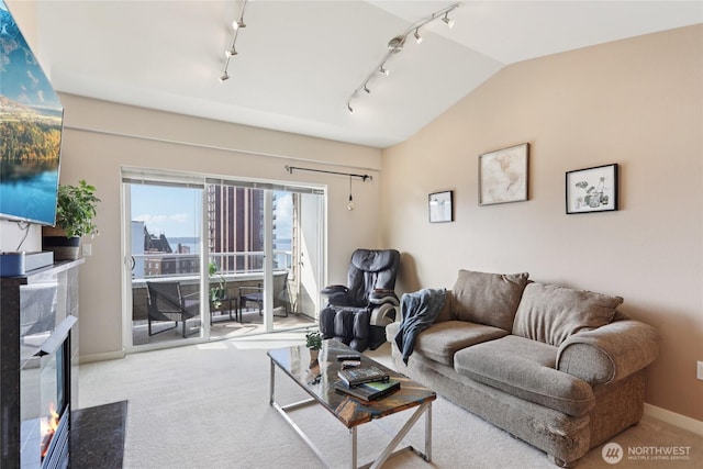 1 Broadway Unit 721, Tacoma, WA 98402 - carpeted living room with track lighting, a fireplace, and vaulted ceiling