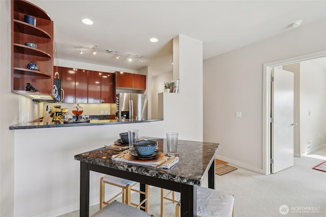 1 Broadway Unit 721, Tacoma, WA 98402 - dining space with light colored carpet, bar with sink, and recessed lighting
