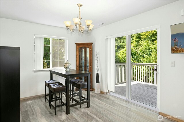 6205 26th St NE, Tacoma, WA 98422 - dining room featuring a chandelier and light wood finished floors