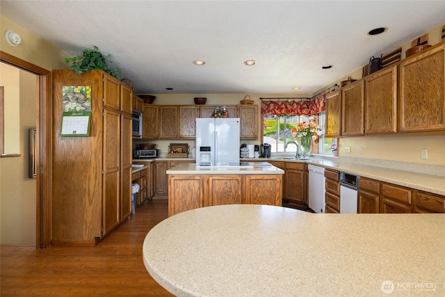 1807 Bradley Dr, Anacortes, WA 98221 - kitchen with white appliances, light countertops, dark wood finished floors, brown cabinets, and recessed lighting