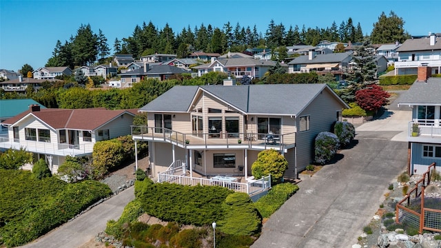 1807 Bradley Dr, Anacortes, WA 98221 - view of front facade featuring a residential view, driveway, and a balcony