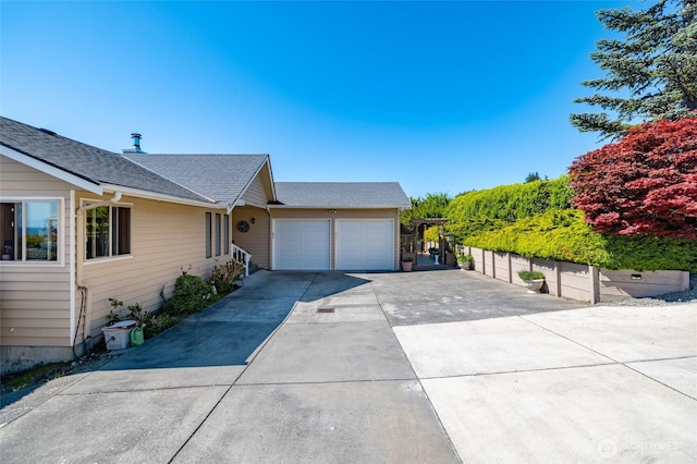 1807 Bradley Dr, Anacortes, WA 98221 - view of front of property with concrete driveway, a garage, and a shingled roof