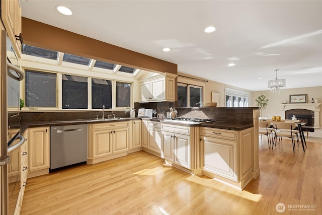 413 213th Pl SE, Sammamish, WA 98074 - kitchen with stainless steel dishwasher, light wood-style flooring, a peninsula, cream cabinets, and a chandelier
