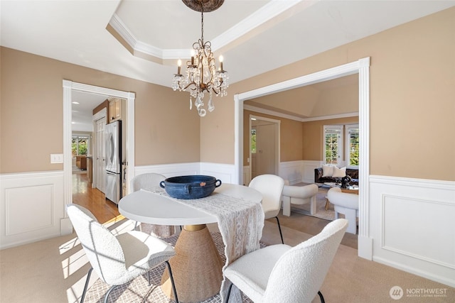 413 213th Pl SE, Sammamish, WA 98074 - dining room with a wainscoted wall, a chandelier, ornamental molding, a raised ceiling, and a decorative wall