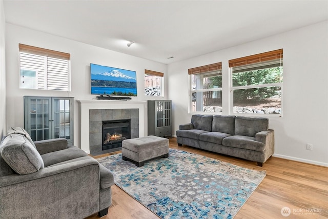 21552 SE 275th Ct, Maple Valley, WA 98038 - living room featuring a tile fireplace and wood finished floors