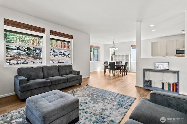21552 SE 275th Ct, Maple Valley, WA 98038 - living room featuring a chandelier, light wood-style floors, and recessed lighting