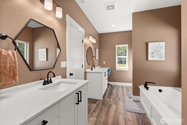 809 NW Gertrude Ave, Winlock, WA 98596 - bathroom with vanity, wood finished floors, and a bath