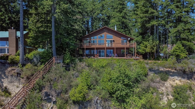 160 Wildwood Shrs, Brinnon, WA 98320 - back of house with a wooden deck and a wooded view