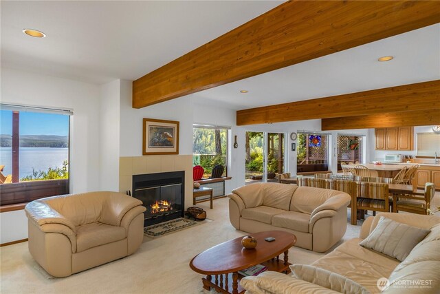 160 Wildwood Shrs, Brinnon, WA 98320 - living room featuring healthy amount of natural light, a tiled fireplace, recessed lighting, light carpet, and beamed ceiling