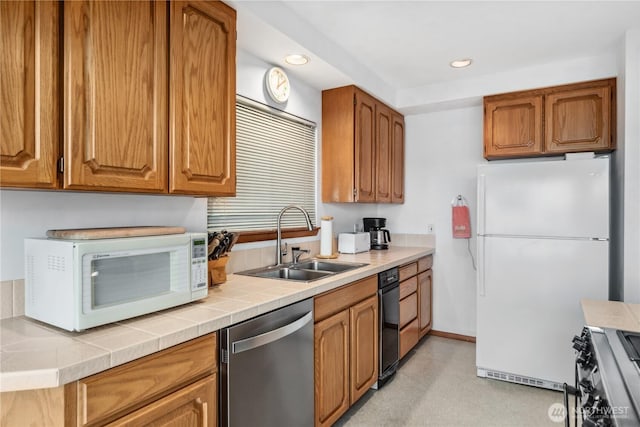160 Wildwood Shrs, Brinnon, WA 98320 - kitchen with stainless steel appliances, brown cabinetry, recessed lighting, and tile countertops
