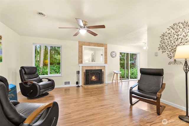 4617 Grandview Dr W Unit D, Tacoma, WA 98466 - living room with a ceiling fan, light wood finished floors, and a tile fireplace