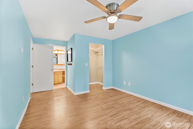 4617 Grandview Dr W Unit D, Tacoma, WA 98466 - unfurnished bedroom with light wood finished floors, a walk in closet, a closet, ceiling fan, and connected bathroom