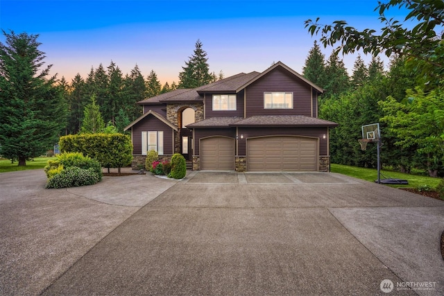 24702 64th Ave E, Graham, WA 98338 - view of front of property with stone siding, a garage, and concrete driveway