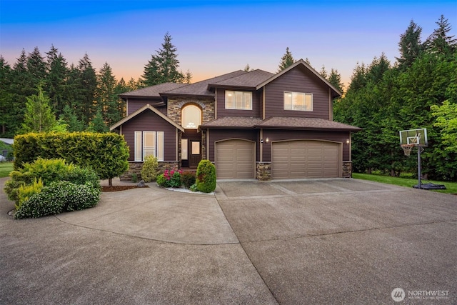 24702 64th Ave E, Graham, WA 98338 - view of front of property with stone siding, driveway, an attached garage, and a shingled roof