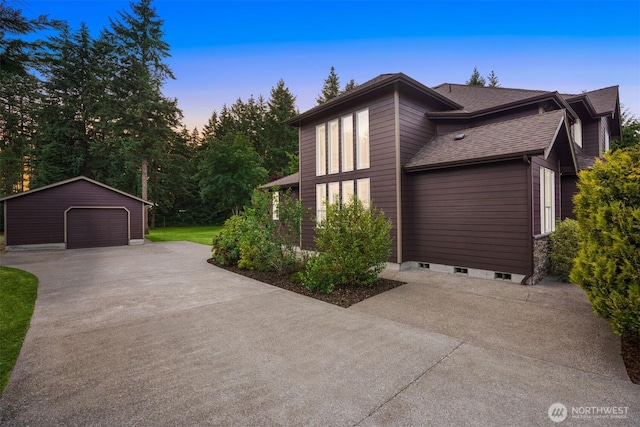 24702 64th Ave E, Graham, WA 98338 - view of front of house featuring a detached garage, driveway, an outbuilding, and roof with shingles