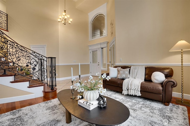 24702 64th Ave E, Graham, WA 98338 - living area with a chandelier, a high ceiling, wood finished floors, and stairs