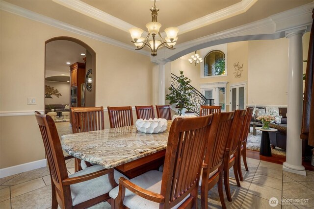 24702 64th Ave E, Graham, WA 98338 - dining area with ornamental molding, a chandelier, arched walkways, a tray ceiling, and decorative columns