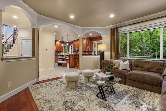 24702 64th Ave E, Graham, WA 98338 - living area with ornate columns, arched walkways, ornamental molding, recessed lighting, and light wood finished floors