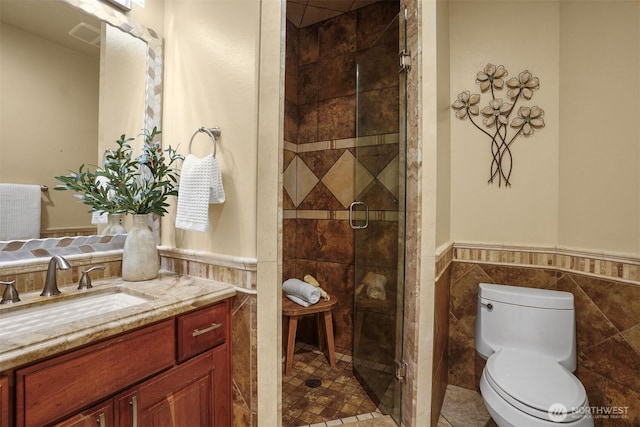 24702 64th Ave E, Graham, WA 98338 - bathroom with vanity, tile walls, a wainscoted wall, and a stall shower