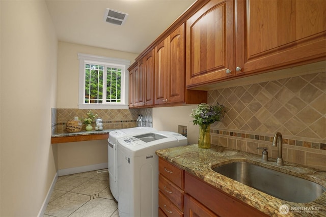 24702 64th Ave E, Graham, WA 98338 - washroom with washing machine and clothes dryer, cabinet space, and light tile patterned flooring