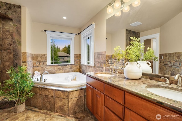 24702 64th Ave E, Graham, WA 98338 - full bath featuring double vanity, a bath, tile walls, and wainscoting
