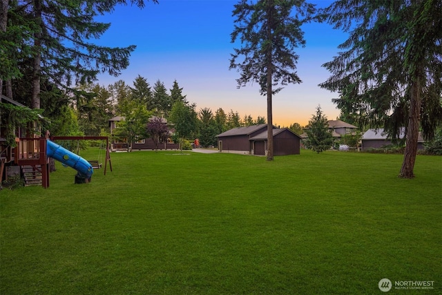 24702 64th Ave E, Graham, WA 98338 - yard at dusk featuring a playground and a lawn