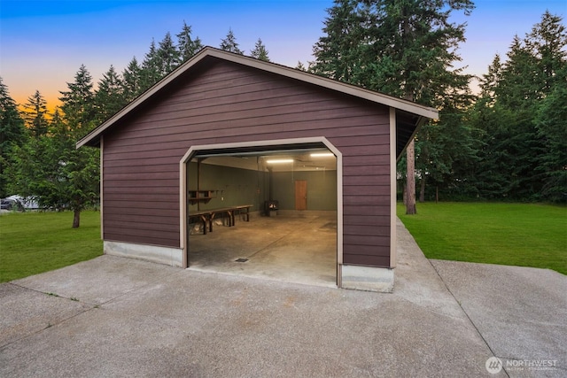 24702 64th Ave E, Graham, WA 98338 - garage at dusk with a detached garage, a yard, and concrete driveway
