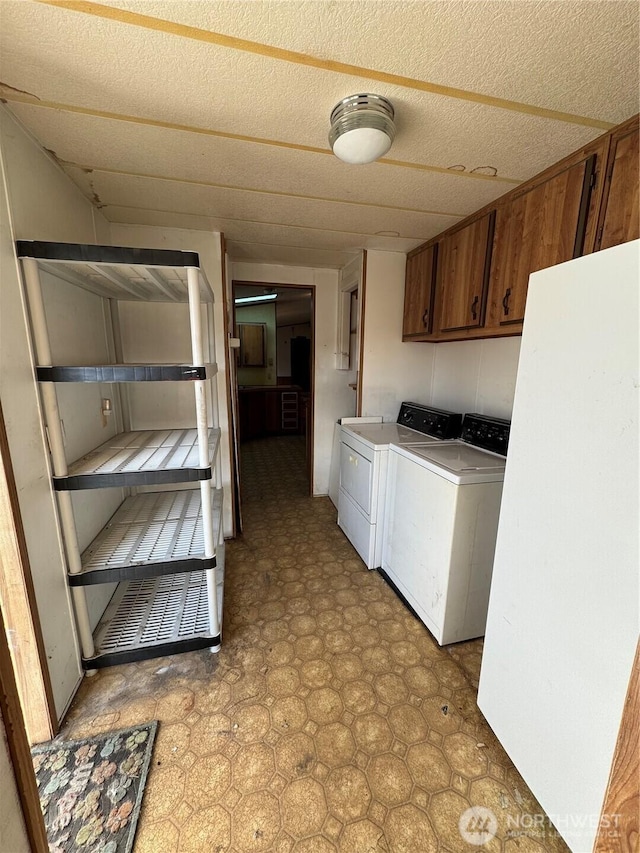 31600 126th Ave SE Unit 100, Auburn, WA 98092 - washroom with light flooring, separate washer and dryer, and cabinet space