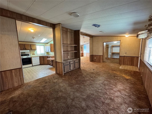 31600 126th Ave SE Unit 100, Auburn, WA 98092 - unfurnished living room featuring wooden walls, light carpet, and a wainscoted wall
