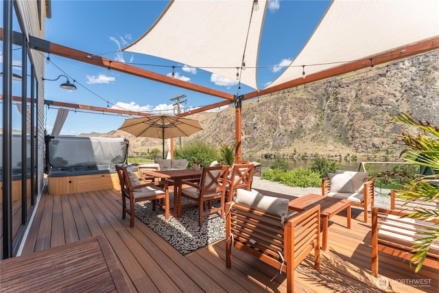 485 Hidden Ln, Chelan, WA 98816 - wooden deck with a covered hot tub and outdoor dining area