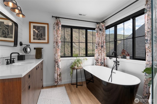 485 Hidden Ln, Chelan, WA 98816 - bathroom featuring vanity, wood finished floors, and a freestanding bath