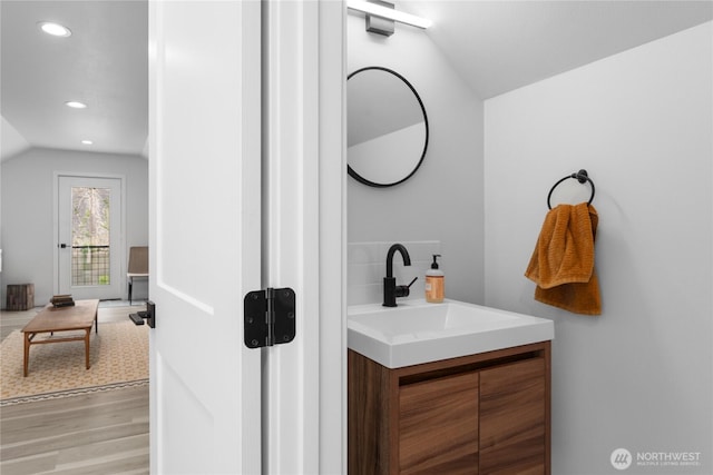 485 Hidden Ln, Chelan, WA 98816 - bathroom featuring wood finished floors, lofted ceiling, recessed lighting, and vanity
