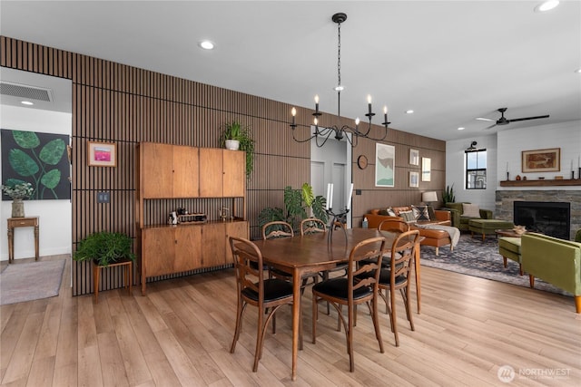 485 Hidden Ln, Chelan, WA 98816 - dining area featuring ceiling fan, light wood-style floors, a fireplace, recessed lighting, and a chandelier