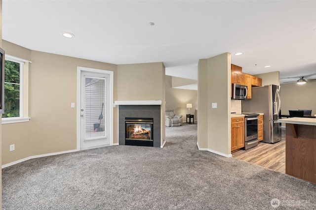 4714 Fairwood Blvd NE Unit 1704, Tacoma, WA 98422 - kitchen featuring stainless steel appliances, light colored carpet, a tile fireplace, recessed lighting, and light countertops