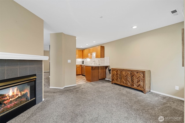 4714 Fairwood Blvd NE Unit 1704, Tacoma, WA 98422 - unfurnished living room featuring light carpet, recessed lighting, and a tiled fireplace